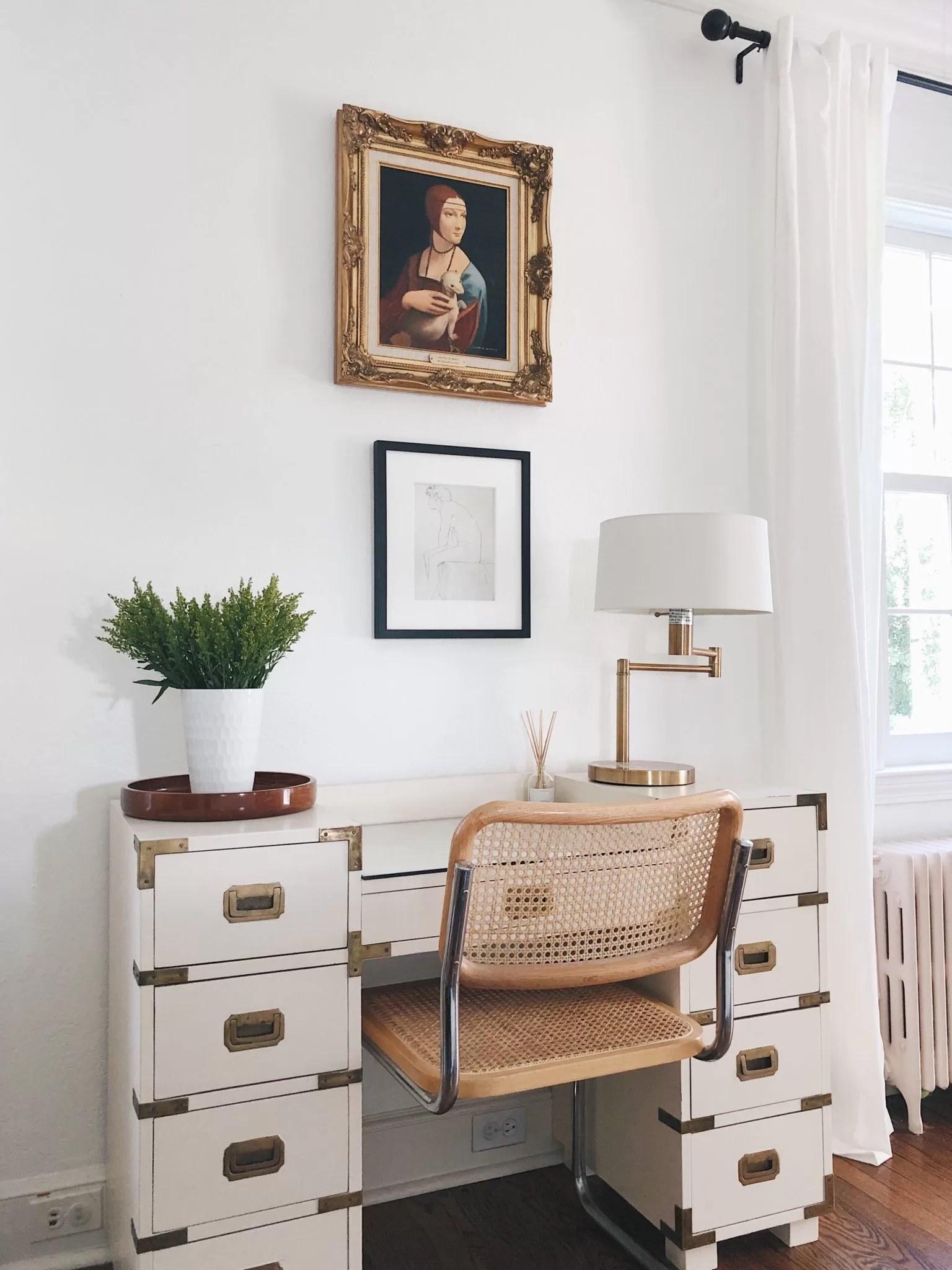 White living room - campaign desk with vintage chair and art