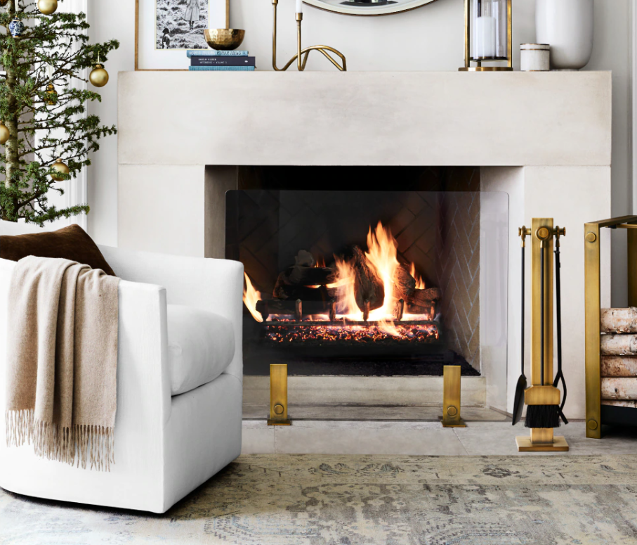 White armchair in front of a fireplace