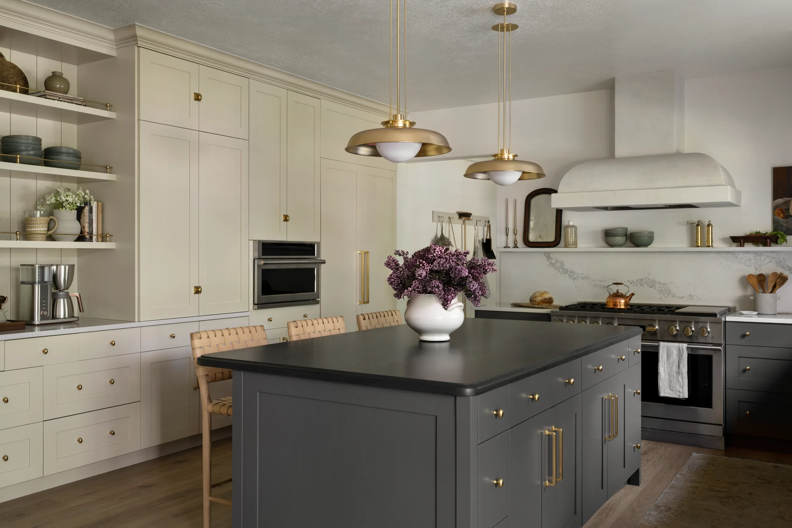 Creamy cupboard fronts, with gold pendant lighting and leather wrap barstools