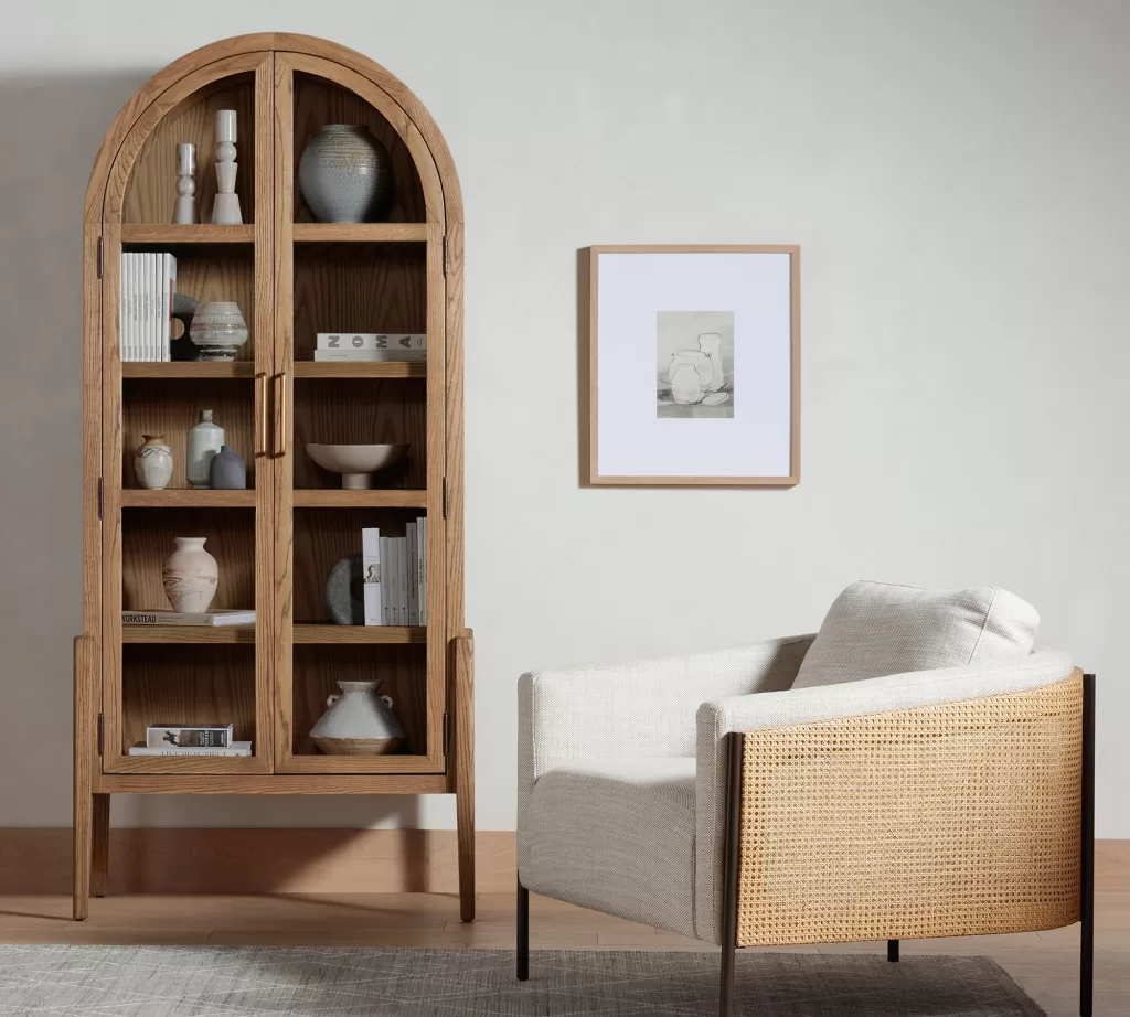 light wood arched cabinet in a neutral room