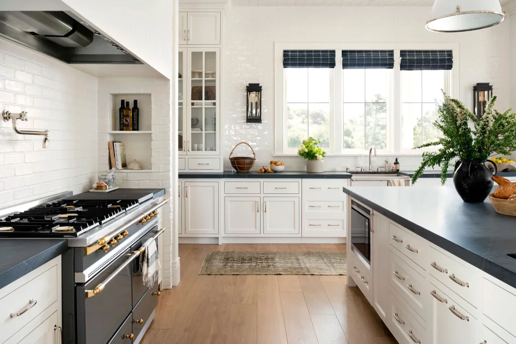 White kitchen with vintage rug and check roman shades