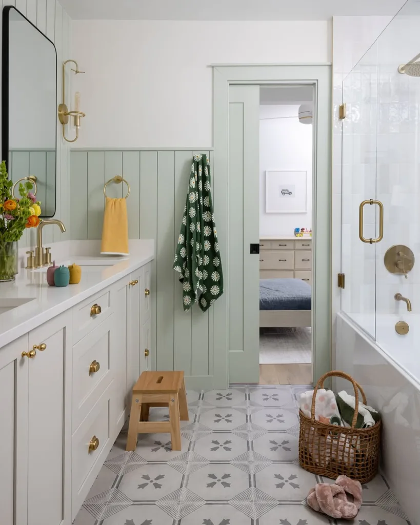 bathrom with patterned floor tile and green walls