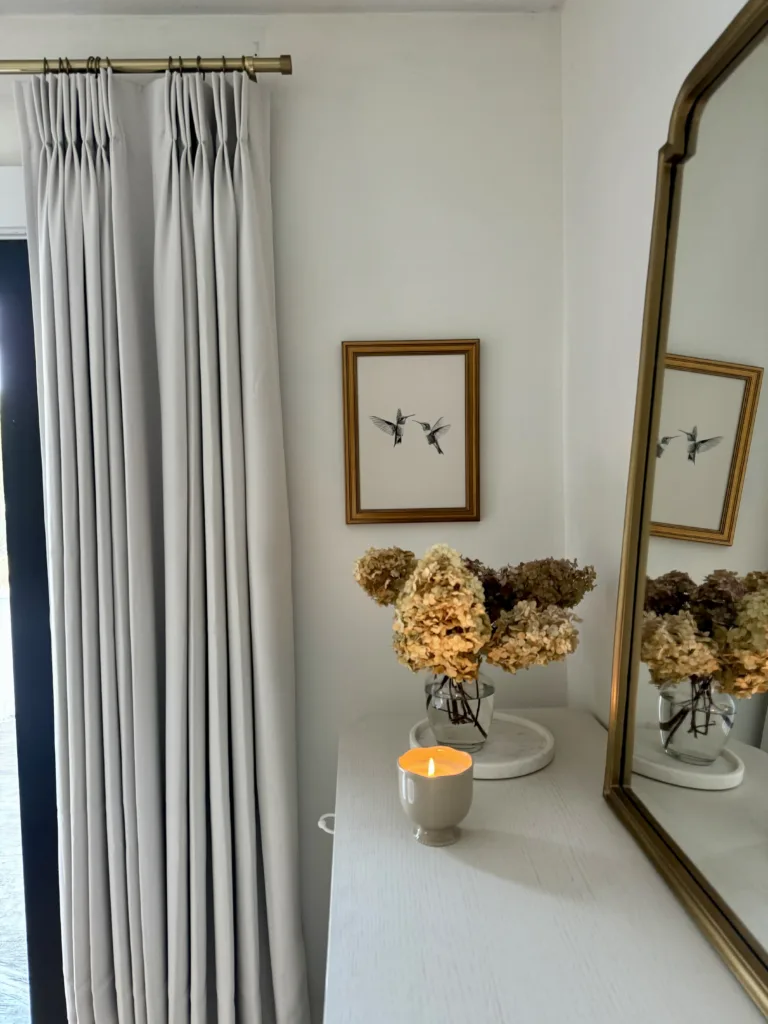 white wall with gold hummingbird art from Amazon